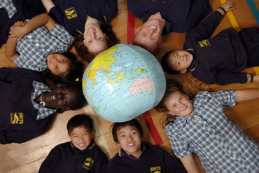 Children with globe lying on the floor