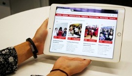 A girl looks at the AEF website on an iPad
