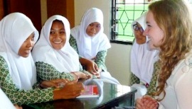 A young girl talks to Indonesian students visiting their school