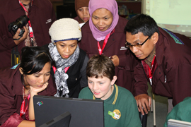 Students and teachers at computer