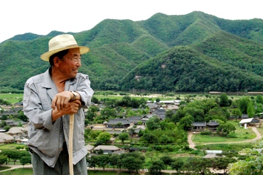 Farmer looks out over his mountains and crops