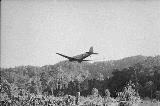 Black and white image of plane flying over Kokoda track