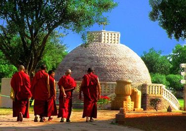 Monks dressed in their red robes visit Sanchi stupa