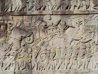 Bas-relief of a noble riding an elephant while hunting with footmen