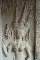 Close-up of a bas-relief of an Angkor dancer wearing an ornate headdress and jewellrya
