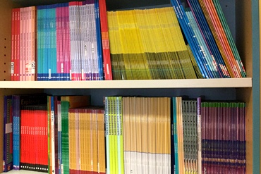 A bookshelf full of educational books and magazines